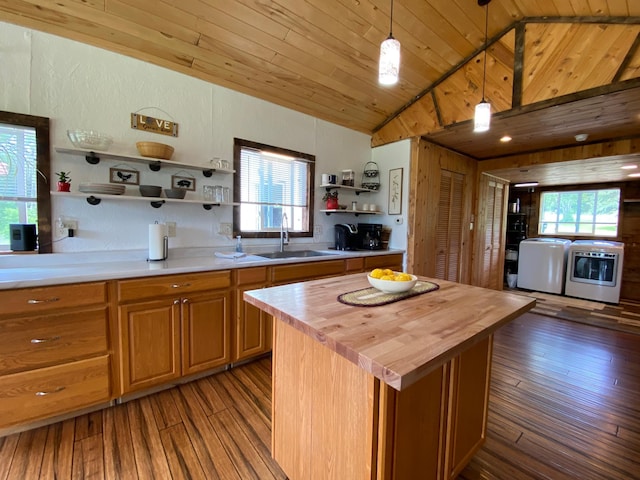 3653 Front St, Barnum, MN 55707 - kitchen featuring wood counters, open shelves, lofted ceiling, wood finished floors, and washing machine and dryer