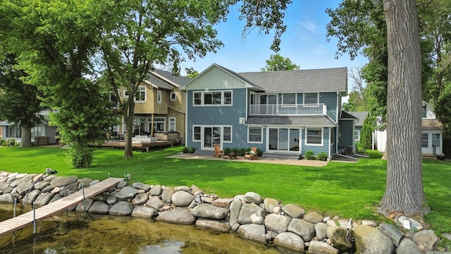 5459 Bartlett Blvd, Mound, MN 55364 - back of house with roof with shingles, a lawn, entry steps, and a water view