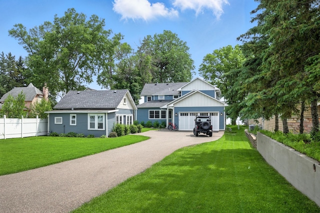 5459 Bartlett Blvd, Mound, MN 55364 - view of front of home featuring asphalt driveway, a shingled roof, and board and batten siding