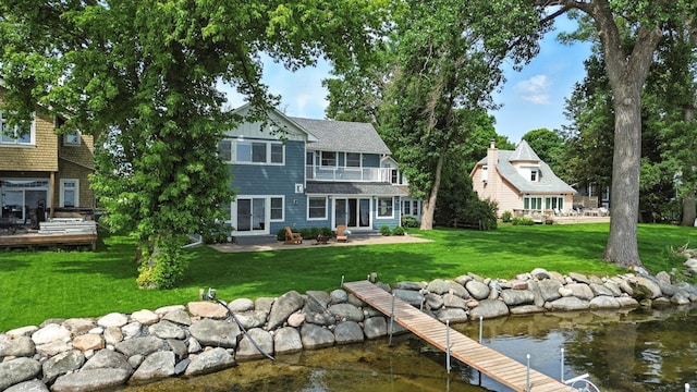 5459 Bartlett Blvd, Mound, MN 55364 - back of property with a balcony, a lawn, and a water view