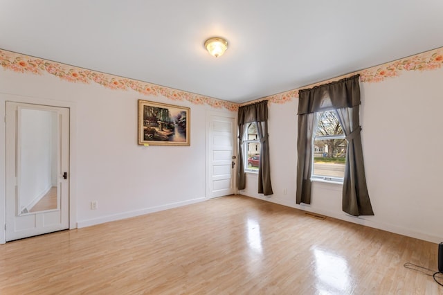 821 5th St, Winona, MN 55987 - empty room with light wood-style flooring and baseboards