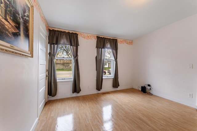 821 5th St, Winona, MN 55987 - spare room featuring light wood-style floors and baseboards