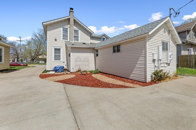 821 5th St, Winona, MN 55987 - rear view of property featuring a chimney and a shingled roof