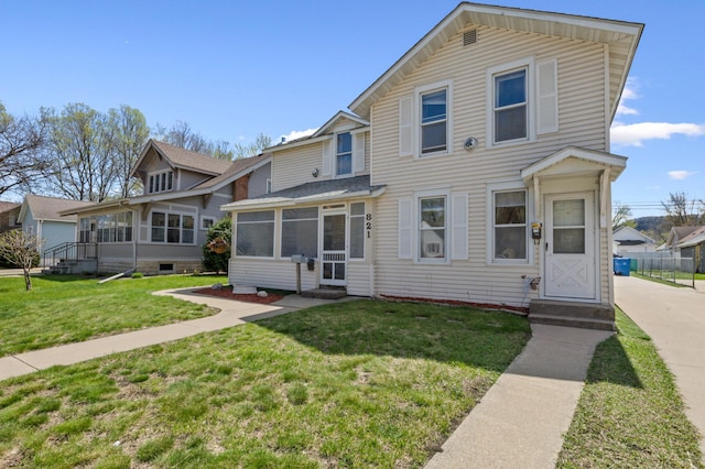 821 5th St, Winona, MN 55987 - view of front of home with a sunroom and a front yard