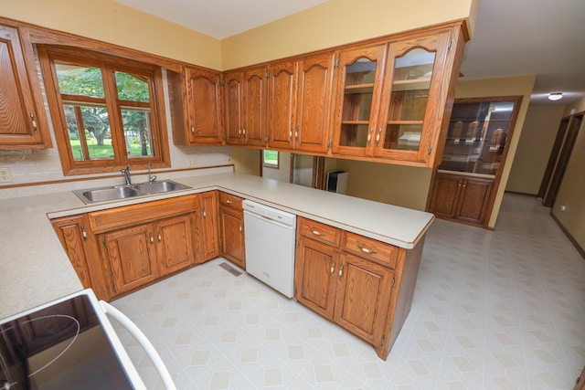 2303 Parkview Rd NE, Alexandria, MN 56308 - kitchen with white dishwasher, a peninsula, light countertops, and brown cabinets