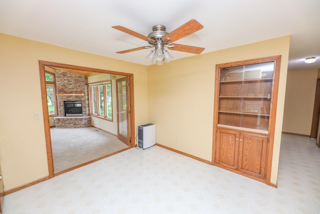 2303 Parkview Rd NE, Alexandria, MN 56308 - empty room with light carpet, a brick fireplace, and ceiling fan