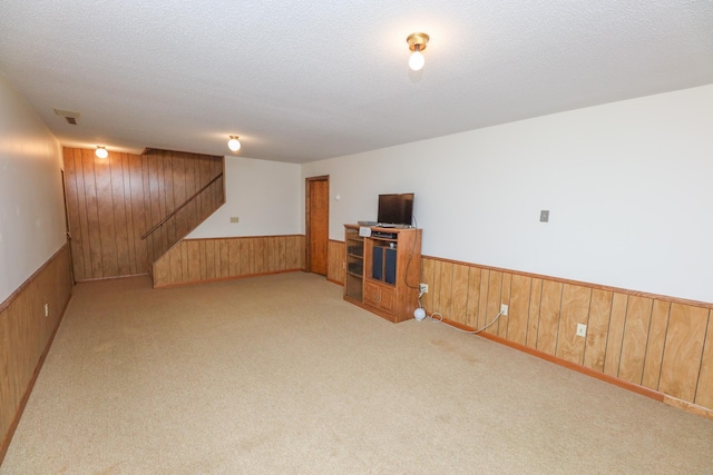 2303 Parkview Rd NE, Alexandria, MN 56308 - finished below grade area with wooden walls, a wainscoted wall, stairway, carpet floors, and a textured ceiling