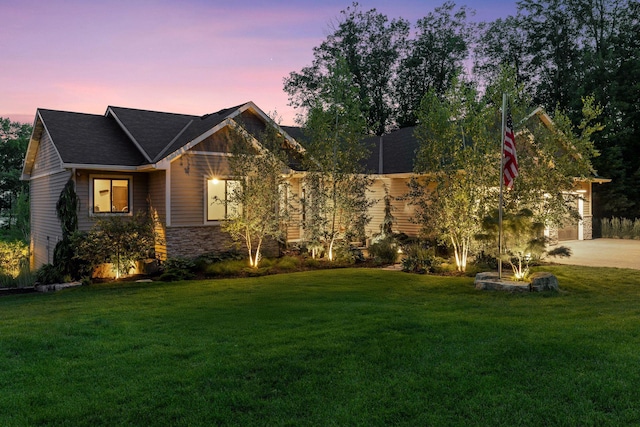12105 285th St, Lindstrom, MN 55045 - view of front facade with a lawn, stone siding, and driveway