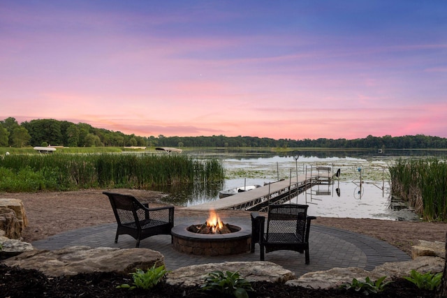 12105 285th St, Lindstrom, MN 55045 - patio terrace at dusk featuring a fire pit, a boat dock, a water view, and boat lift
