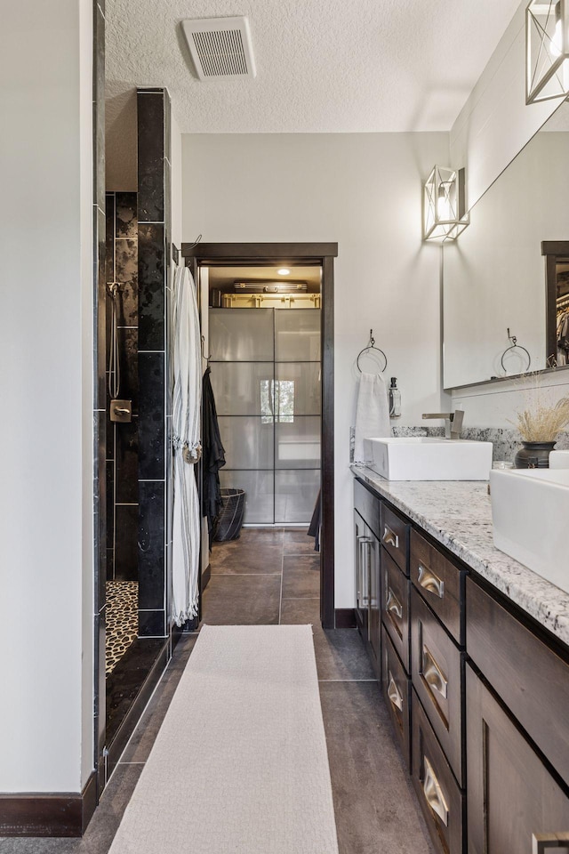 12105 285th St, Lindstrom, MN 55045 - full bath featuring double vanity, a stall shower, and a textured ceiling