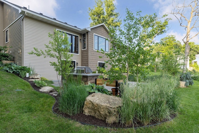 12105 285th St, Lindstrom, MN 55045 - view of side of property featuring area for grilling and a lawn
