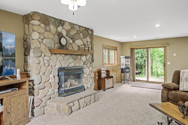 3894 Kestrel St SW, Prior Lake, MN 55372 - living area with carpet floors, a stone fireplace, ceiling fan, a wainscoted wall, and recessed lighting