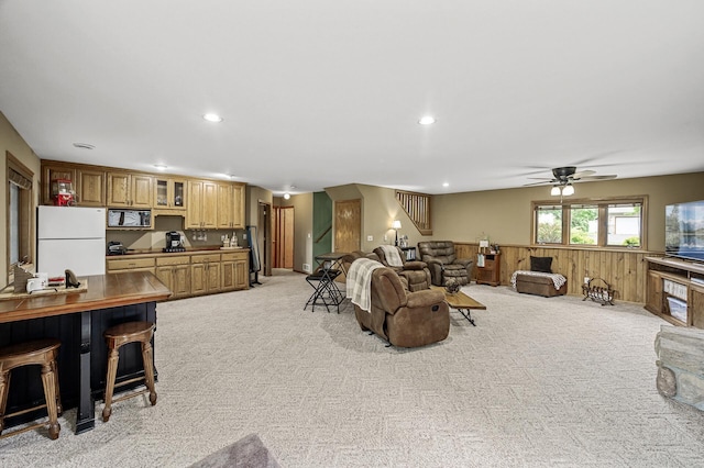 3894 Kestrel St SW, Prior Lake, MN 55372 - living room with light colored carpet, recessed lighting, ceiling fan, a wainscoted wall, and wooden walls