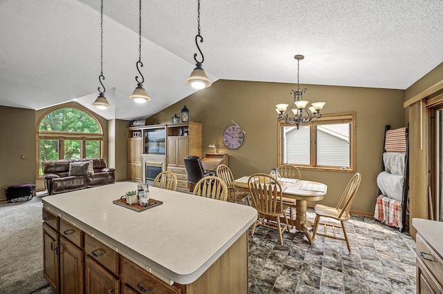 3894 Kestrel St SW, Prior Lake, MN 55372 - kitchen featuring lofted ceiling, a chandelier, light countertops, decorative light fixtures, and a textured ceiling