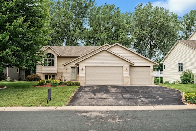 3894 Kestrel St SW, Prior Lake, MN 55372 - split level home with brick siding, asphalt driveway, a garage, and a front yard