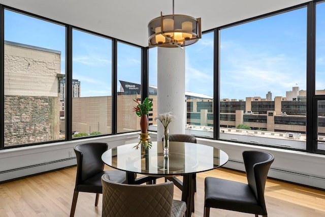 740 Portland Ave Unit 801, Minneapolis, MN 55415 - dining area featuring healthy amount of natural light, a chandelier, wood finished floors, and a wall of windows