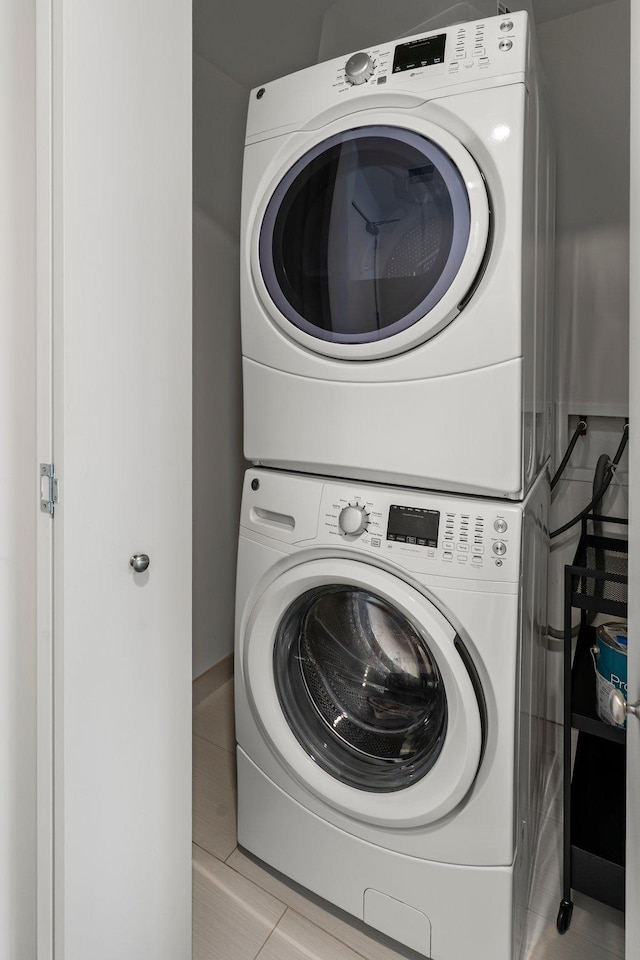 740 Portland Ave Unit 801, Minneapolis, MN 55415 - laundry area with stacked washer and clothes dryer and tile patterned floors