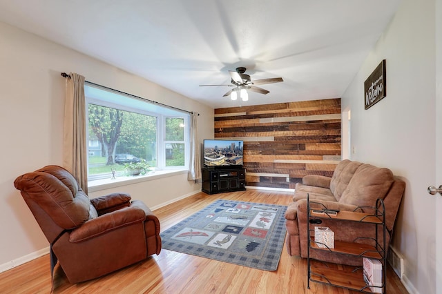 16725 Anna Trl SE, Prior Lake, MN 55372 - living area featuring ceiling fan, wooden walls, and wood finished floors