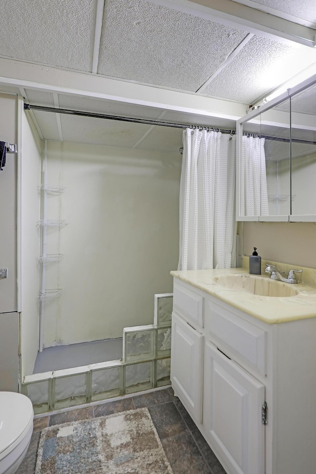 16725 Anna Trl SE, Prior Lake, MN 55372 - bathroom featuring a shower with curtain, vanity, and stone finish floors