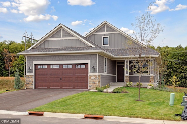 13676 Park Haven Trl, Prior Lake, MN 55372 - craftsman house featuring board and batten siding, stone siding, a garage, a front lawn, and driveway