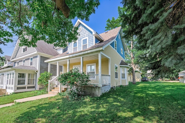 2931 Lyndale Ave N, Minneapolis, MN 55411 - view of front of property featuring covered porch, a front lawn, and roof with shingles