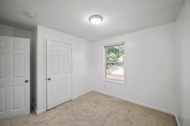 2931 Lyndale Ave N, Minneapolis, MN 55411 - unfurnished bedroom featuring carpet floors and a textured ceiling