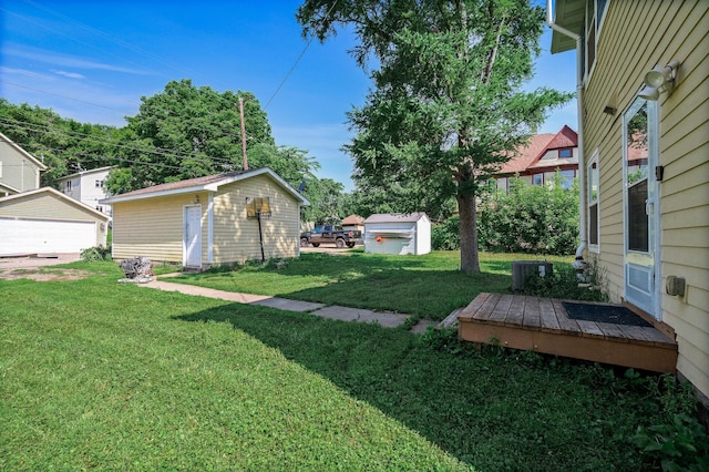 2931 Lyndale Ave N, Minneapolis, MN 55411 - view of grassy yard featuring an outbuilding, a deck, and a garage