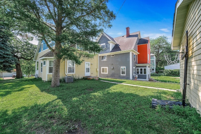 2931 Lyndale Ave N, Minneapolis, MN 55411 - rear view of property featuring a lawn and a chimney