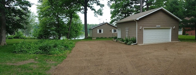 1959 79th St, Georgetown Twp, WI 54853 - view of front of home with a detached garage, an outbuilding, and dirt driveway