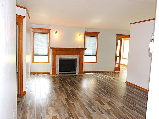 38 Glenview Loop, Saint Cloud, MN 56303 - unfurnished living room with wood finished floors, plenty of natural light, and a fireplace with flush hearth