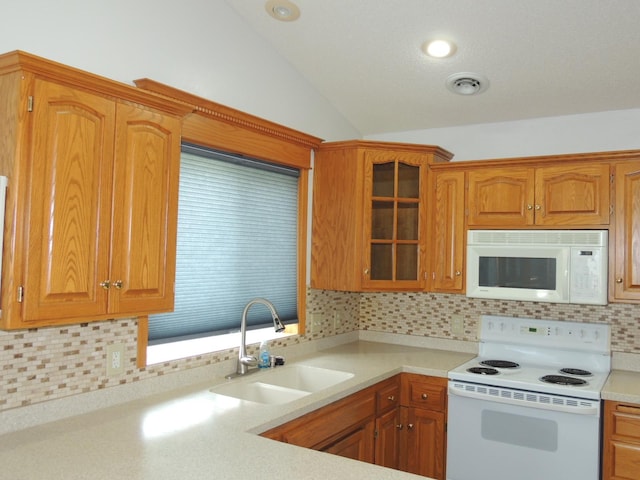 38 Glenview Loop, Saint Cloud, MN 56303 - kitchen with white appliances, lofted ceiling, light countertops, tasteful backsplash, and glass insert cabinets