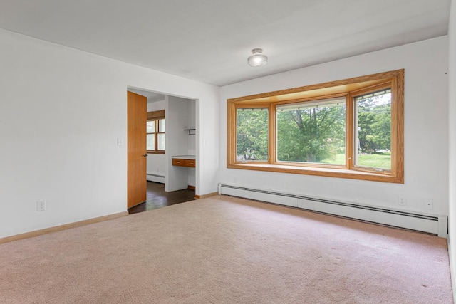 713 Sherman St, North Mankato, MN 56003 - unfurnished room featuring baseboard heating and dark carpet