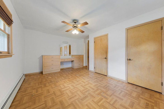 713 Sherman St, North Mankato, MN 56003 - unfurnished bedroom featuring a baseboard heating unit, a desk, and a ceiling fan