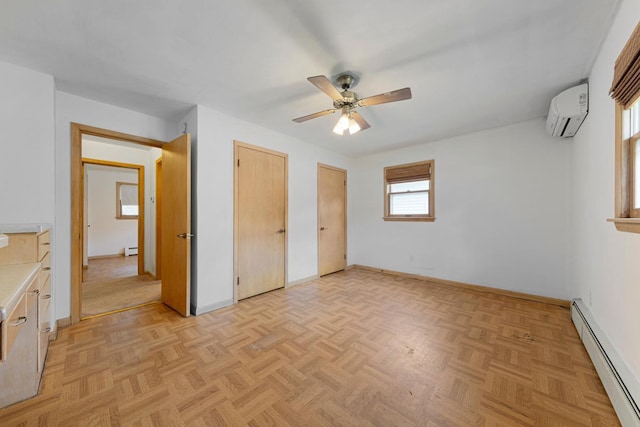 713 Sherman St, North Mankato, MN 56003 - unfurnished bedroom featuring a baseboard heating unit, an AC wall unit, multiple closets, and a ceiling fan