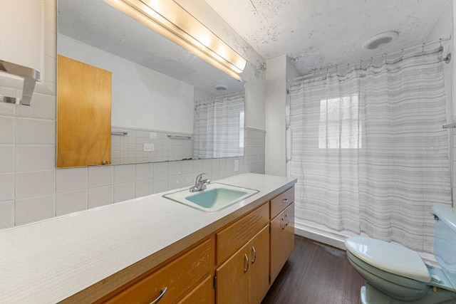 713 Sherman St, North Mankato, MN 56003 - bathroom featuring vanity, wood finished floors, a shower with curtain, and backsplash