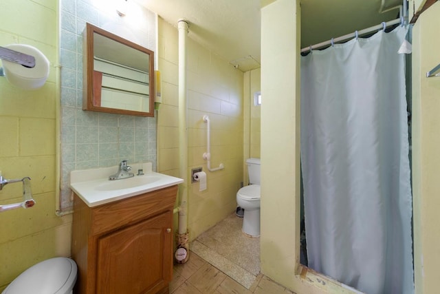 713 Sherman St, North Mankato, MN 56003 - bathroom with tile walls, vanity, and curtained shower