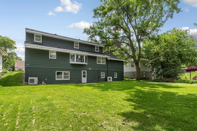 713 Sherman St, North Mankato, MN 56003 - back of house featuring a lawn