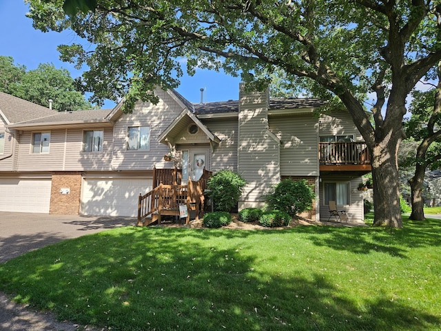 217 Galtier Pl, Shoreview, MN 55126 - view of front of house featuring asphalt driveway, a chimney, a front yard, a garage, and brick siding