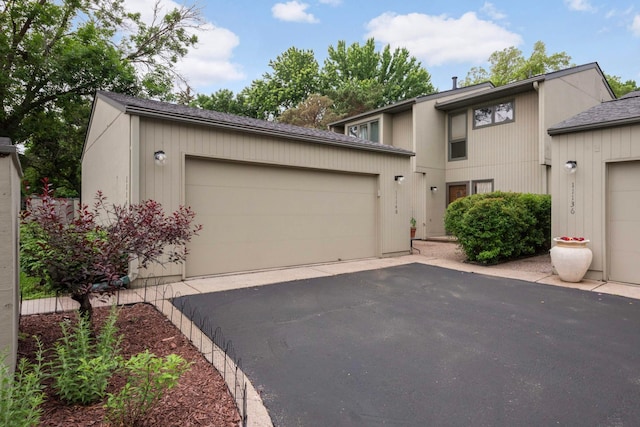 11140 Abbott Ln, Minnetonka, MN 55343 - mid-century inspired home featuring an attached garage and asphalt driveway