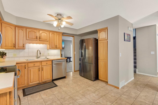 11140 Abbott Ln, Minnetonka, MN 55343 - kitchen featuring stainless steel appliances, ceiling fan, decorative backsplash, light countertops, and light tile patterned floors