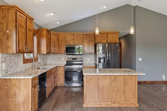 1664 Otter Way, New Richmond, WI 54017 - kitchen featuring appliances with stainless steel finishes, lofted ceiling, dark wood-style flooring, a kitchen island, and light stone counters