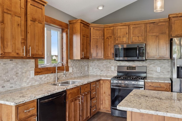 1664 Otter Way, New Richmond, WI 54017 - kitchen with appliances with stainless steel finishes, vaulted ceiling, light stone counters, dark wood-type flooring, and brown cabinetry
