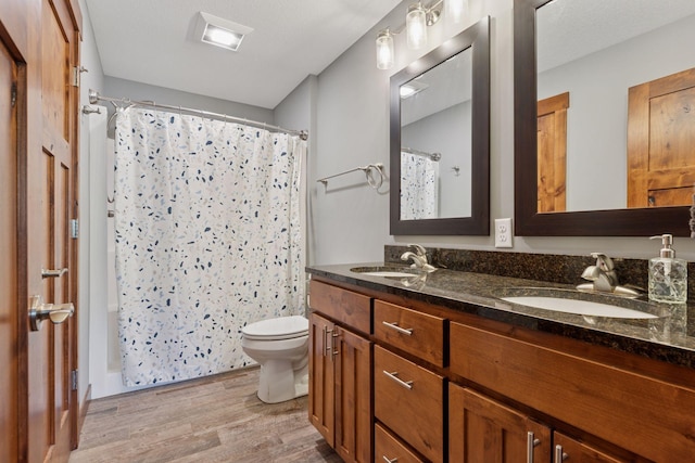 1664 Otter Way, New Richmond, WI 54017 - bathroom featuring wood finished floors, double vanity, and shower / bath combination with curtain