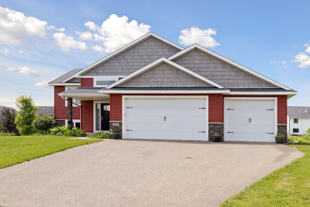 1664 Otter Way, New Richmond, WI 54017 - craftsman-style house featuring stone siding, a front lawn, and driveway