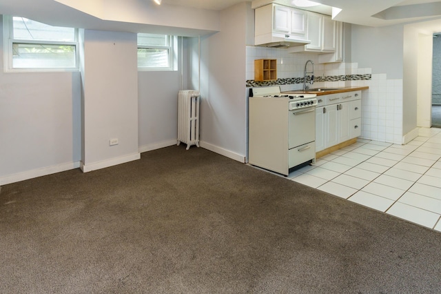 4720 Nicollet Ave Unit 5, Minneapolis, MN 55419 - kitchen with white range with gas stovetop, radiator heating unit, under cabinet range hood, white cabinets, and light carpet