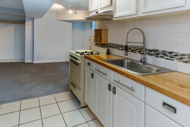 4720 Nicollet Ave Unit 5, Minneapolis, MN 55419 - kitchen with white gas stove, butcher block counters, light carpet, under cabinet range hood, and white cabinetry