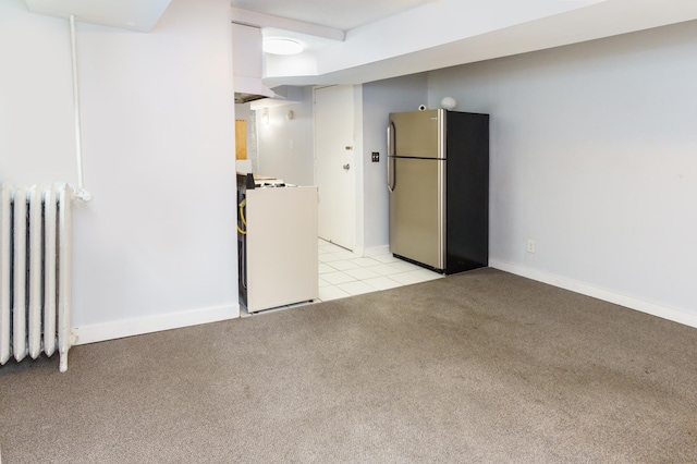 4720 Nicollet Ave Unit 5, Minneapolis, MN 55419 - finished below grade area featuring freestanding refrigerator, radiator heating unit, light colored carpet, washer / dryer, and light tile patterned floors