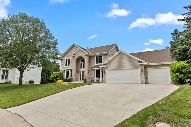 1541 Wexford Ct, Eagan, MN 55122 - traditional-style house with driveway, an attached garage, a front lawn, brick siding, and roof with shingles