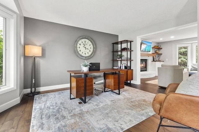 1541 Wexford Ct, Eagan, MN 55122 - home office featuring a fireplace, dark wood-style floors, and recessed lighting