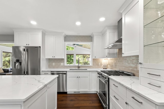 1541 Wexford Ct, Eagan, MN 55122 - kitchen featuring appliances with stainless steel finishes, wall chimney exhaust hood, recessed lighting, plenty of natural light, and decorative backsplash